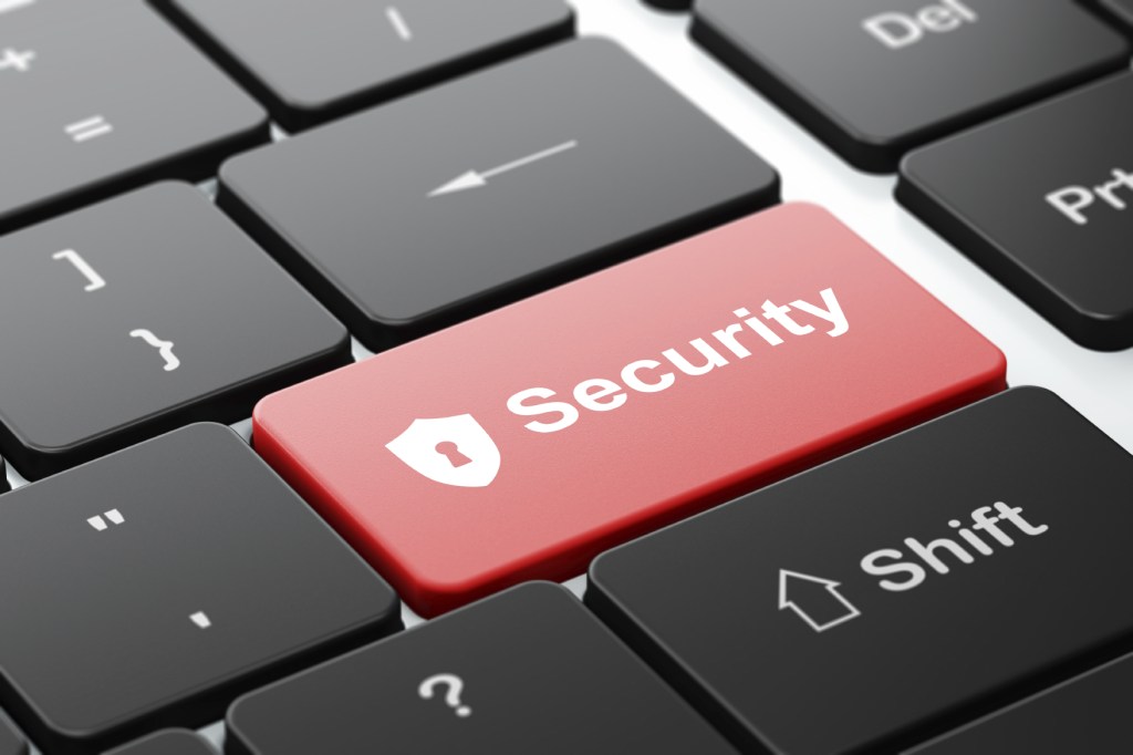 Protection concept: Shield With Keyhole and Security on keyboard
